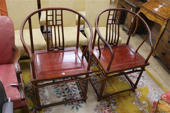 A pair of Chinese hardwood elbow chairs,